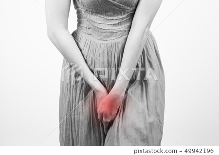 Close up of a woman with hands holding her crotch 49942196