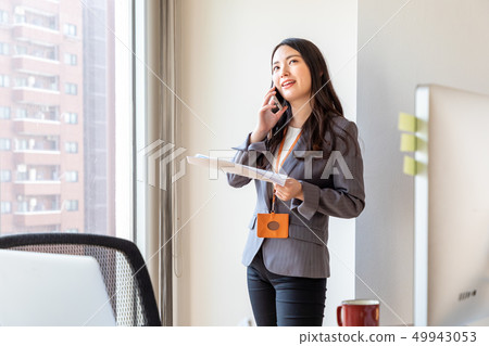 Businesswoman talking on smartphone Businesswoman talking on smartphone 49943053