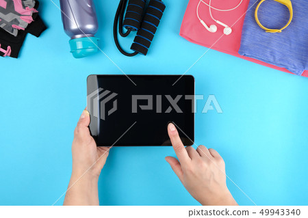 female hands holding an electronic tablet female hands holding an electronic tablet 49943340