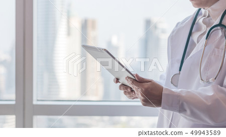 Physician with tablet for patient health record Physician with tablet for patient health record 49943589