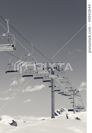 Chair-lift and snowy slope at ski resort on winter 49943644