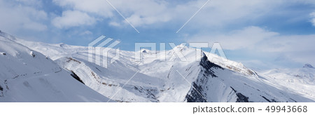 Panorama of snowy winter mountains and blue sky 49943668