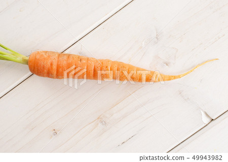 Fresh orange carrot on grey wood Fresh orange carrot on grey wood 49943982