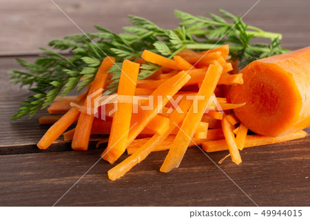 Fresh orange carrot on brown wood 49944015