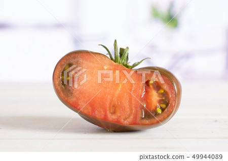 Fresh dark tomato primora with red tulips Fresh dark tomato primora with red tulips 49944089