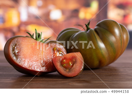 Fresh dark tomato primora with rustic kitchen Fresh dark tomato primora with rustic kitchen 49944158