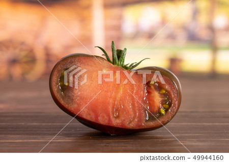 Fresh dark tomato primora with cart 49944160