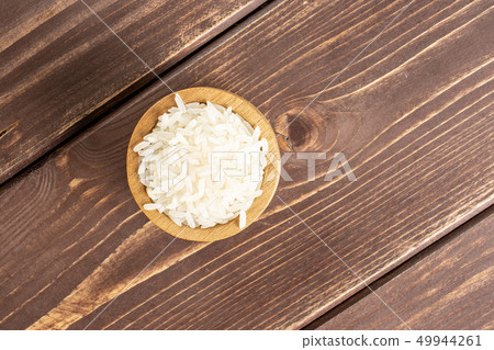 White jasmine rice on brown wood 49944261