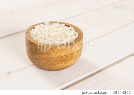 White jasmine rice on grey wood White jasmine rice on grey wood 49944262