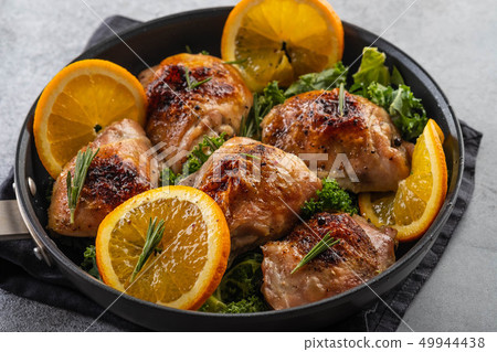 Chicken thighs with orange is a pan. 49944438