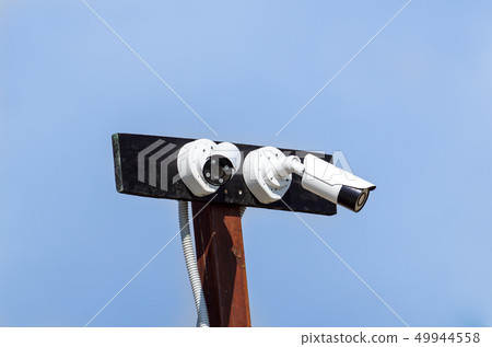Security cctv cameras in front of blue sky 49944558