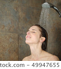 Relaxed woman showering in a shower 49947655
