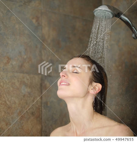 Relaxed woman showering in a shower 49947655