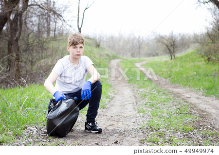 The guy in the white T-shirt collects trash  49949974