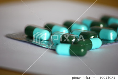 green-blue antibiotic capsule pills in blister green-blue antibiotic capsule pills in blister 49951023