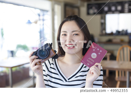 A young woman preparing for traveling abroad 49952355