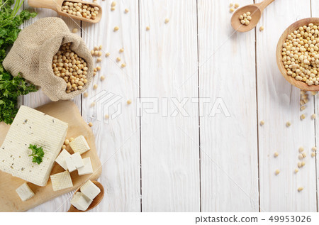 Soy Bean curd tofu on cutting board and in hemp Soy Bean curd tofu on cutting board and in hemp 49953026
