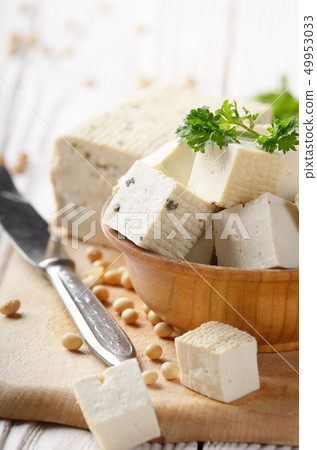 Soy Bean curd tofu in wooden bowl on white wooden Soy Bean curd tofu in wooden bowl on white wooden 49953033