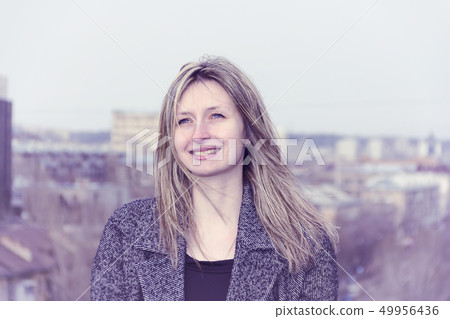 Portrait of a girl on the roof of the building. Portrait of a girl on the roof of the building. 49956436