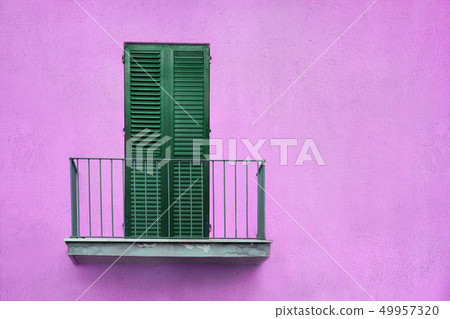 metallic gray balcony with green wooden sash door with shutters on lilac wall metallic gray balcony with green wooden sash door with shutters on lilac wall 49957320
