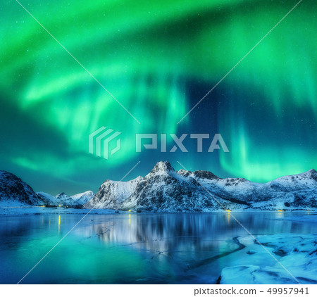 Aurora borealis over snowy mountains, frozen sea 49957941