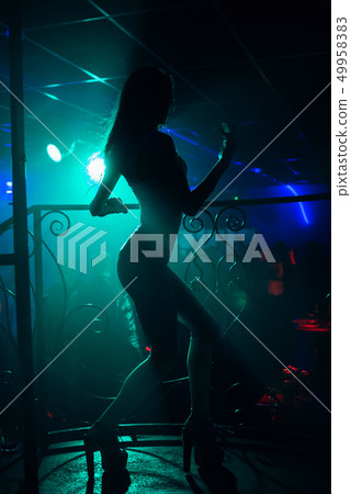girl go-go dancer posing in a nightclub on stage girl go-go dancer posing in a nightclub on stage 49958383