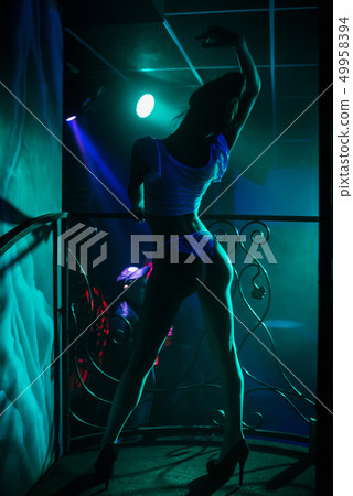 girl go-go dancer posing in a nightclub on stage 49958394