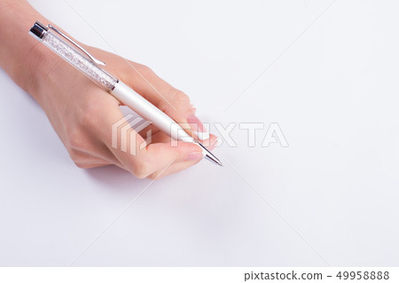Beautiful female hand with manicure hold a pen. Beautiful female hand with manicure hold a pen. 49958888