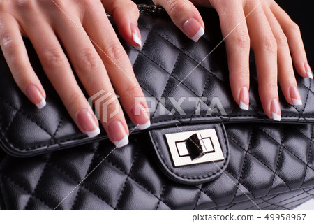 Beautiful french manicure with leather bag. 49958967