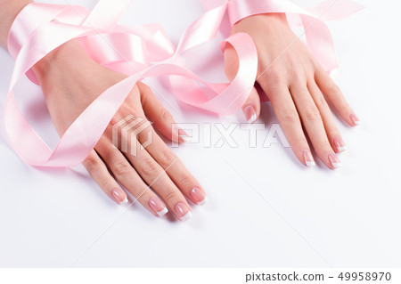 Manicure with delicate pink ribbon. Manicure with delicate pink ribbon. 49958970