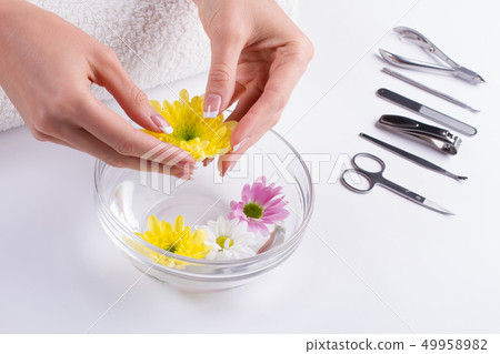 French manicure with beautiful flowers. French manicure with beautiful flowers. 49958982