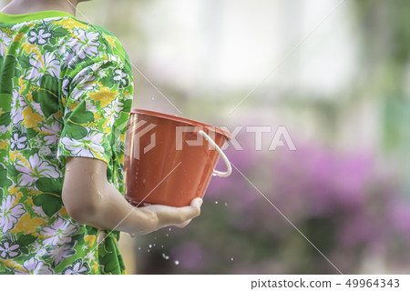 Hand holding Plastic bucket play Songkran festival Hand holding Plastic bucket play Songkran festival 49964343