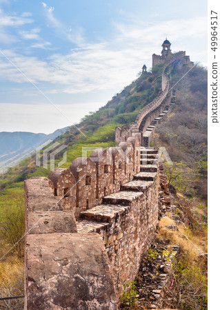 Ancient long wall with towers around Amber Fort. Ancient long wall with towers around Amber Fort. 49964517