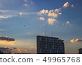 Airplane flying to the sunset 49965768