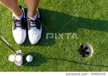Top View golfer asian sporty woman focus putting Top View golfer asian sporty woman focus putting 49969549