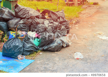 Pile garbage black bag plastic roadside Pile garbage black bag plastic roadside 49970658
