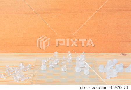chess glass on board in game. On a vintage wooden 49970673