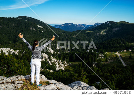 Woman traveler hiking across Croatia landscape. Woman traveler hiking across Croatia landscape. 49971998