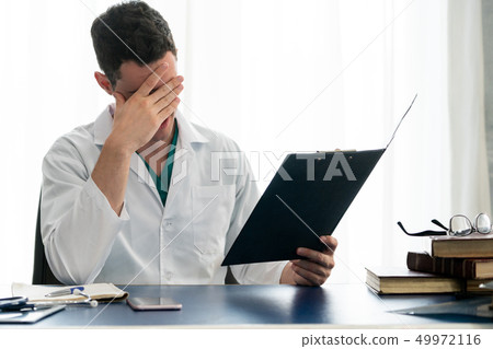 Doctor working in hospital office. Doctor working in hospital office. 49972116