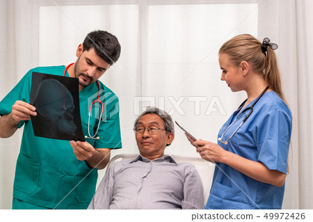 Doctor team work with x ray film image of patient. 49972426