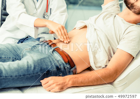 Woman Doctor and Male Patient in Hospital Office 49972597