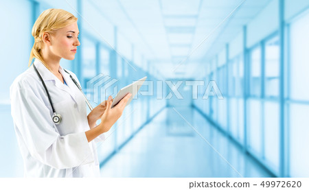 Doctor using tablet computer at the hospital. Doctor using tablet computer at the hospital. 49972620