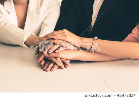 Teamwork business people join hands in meeting. Teamwork business people join hands in meeting. 49972824