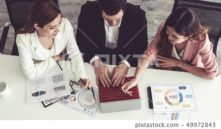 Businessman and businesswomen working in office. 49972843