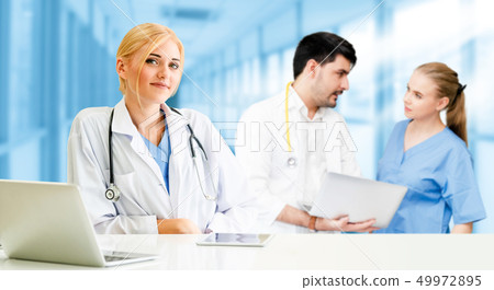 Doctor working in hospital with other doctors. Doctor working in hospital with other doctors. 49972895