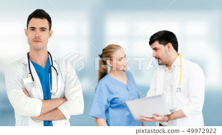 Doctor working in hospital with other doctors. Doctor working in hospital with other doctors. 49972922