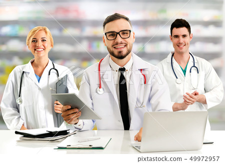 Doctor working in hospital with other doctors. Doctor working in hospital with other doctors. 49972957
