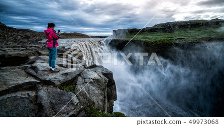Traveler Travels to Dettifoss Waterfall in Iceland Traveler Travels to Dettifoss Waterfall in Iceland 49973068
