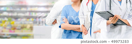 Doctor working in hospital with other doctors. 49973283