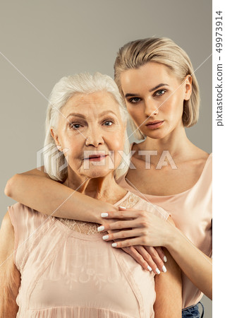 Beautiful blonde young woman hugging her mother 49973914